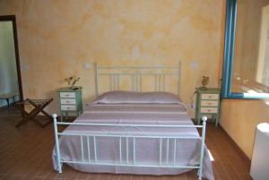 a bedroom with a bed and two night stands at Agriturismo La Turritella in Rende