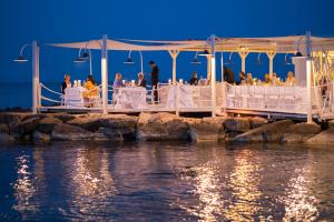 a wedding ceremony on a pier over the water at La Peschiera in Monopoli