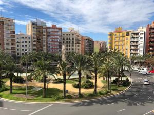 a city street with palm trees and buildings at Cosy Flats Luceros in Alicante