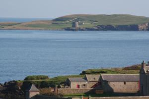 a view of a body of water with a lighthouse at Tamara Apartment in Sandwick