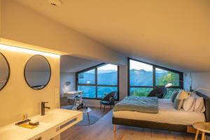 a bedroom with a bed and a bathroom with windows at IXUA Hotela in Éibar