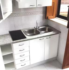 a small kitchen with a sink and a window at Foz do Arelho Beach Apartment "Blue" in Foz do Arelho