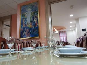 a table with plates and wine glasses on it at Hotel No-1 in Međugorje +30 photos