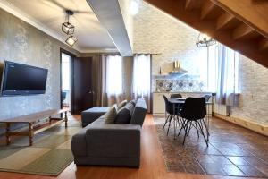 a living room with a couch and a table at Iliani Hotel in Tbilisi City