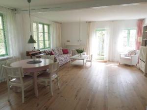 a living room with a table and a couch at Hof Rodenkrog in Lütjenburg