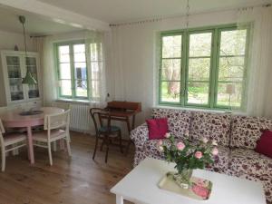 a living room with a couch and a table at Hof Rodenkrog in Lütjenburg
