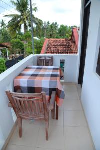 a table and chairs on a balcony with a view at Holiday Home Bentota in Bentota