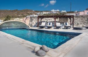 a swimming pool with chairs and a gazebo at Sophia Finikia Villas in Oia