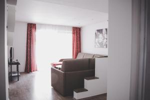 a living room with a couch and a window at Apartma Trebušca in Dolenja Trebuša