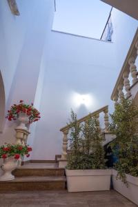 a stairway with two potted plants and some stairs at Charme B&B Dimora Quarta in Leverano