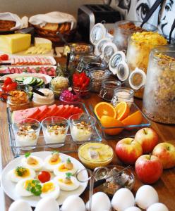 a table with eggs and fruits and other food at 5:ans Bed & Breakfast in Gothenburg