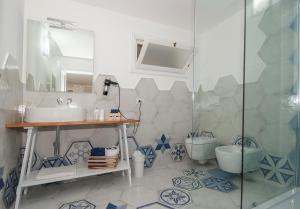 a bathroom with a sink and a toilet at Dimora Mediterranea in Mattinata +50 photos