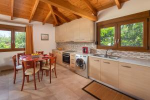 a kitchen with a table and a dining room at Green Oasis House in Filerimos in Ialysos