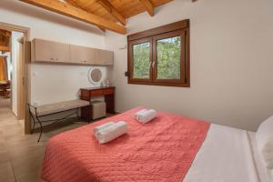a bedroom with a bed with two pillows on it at Green Oasis House in Filerimos in Ialysos