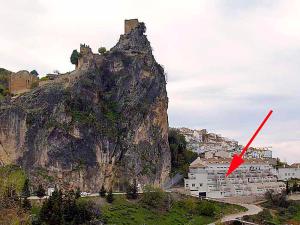 a mountain with a red arrow on top of it at Mirador Castillo La Iruela in Cazorla +8 photos