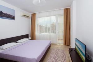 a bedroom with a bed and a large window at Complex Moskoyani in Nesebar +121 photos
