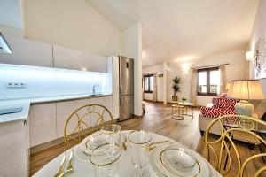 a kitchen and living room with a table and chairs at Palma Old Town - Turismo de Interior in Palma de Mallorca