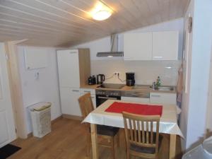 a small kitchen with a table and chairs in a room at Bergfreiheit in Schierke