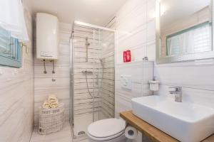 a bathroom with a toilet and a sink and a shower at Vila Saja in Selce +25 photos