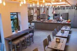a restaurant with tables and chairs and a counter at Comfotel PRPL in London