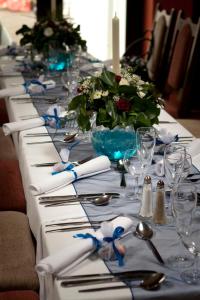 a long table with plates and glasses and flowers on it at Myles Creek in Kilkee