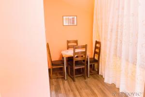 a dining room with a table and chairs at Guesthouse Bato in Virpazar