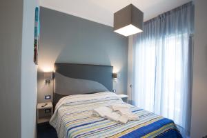 a bedroom with a bed with two towels on it at Residenza Sole Maiori in Maiori