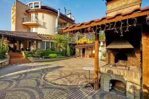 a courtyard with a brick oven in front of a building at Dvorik Leva in Truskavets