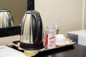 a coffee maker on a tray on a kitchen counter at Streets of Gold Guest House in Gaborone