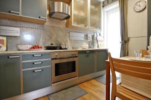 a kitchen with stainless steel cabinets and a stove at Apartament Monte Mario in Rome