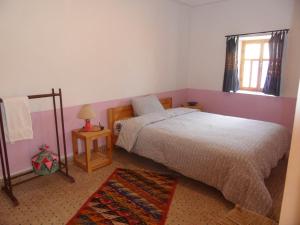 een slaapkamer met een bed en een raam bij Gite Tigmi Azrur in Tabant