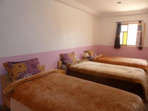 Uma cama ou camas num quarto em Gite Tigmi Azrur