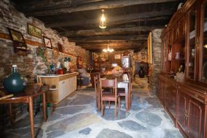 a kitchen with a table and chairs in a room at Pensión Santa Rosa in Samos