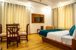 a bedroom with a bed and a table and a chair at Jade Vine Resort in Shogi