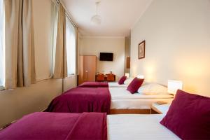 Posteľ alebo postele v izbe v ubytovaní Mały Kraków Aparthotel