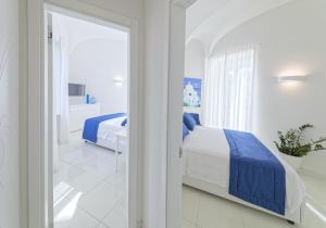 En eller flere senge i et værelse på Exclusive Home Ischia