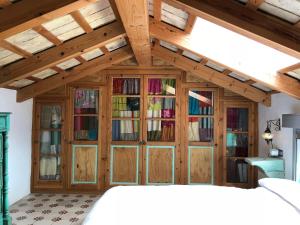 a bedroom with a large wooden cabinet with glass doors at Cortijito dúplex Mangueta in El Palmar