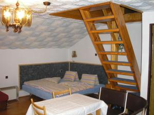 ein Schlafzimmer mit einem Bett und einer Holztreppe in der Unterkunft Bungalow Škrabálek in Rokytnice nad Jizerou