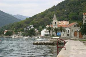 a body of water next to a town with boats at Apartment Diana in Tivat