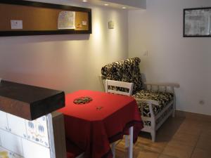 ein Wohnzimmer mit einem roten Tisch und einem Stuhl in der Unterkunft Le Clos des Alouettes in Amboise