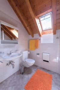 a bathroom with a toilet and a sink and a window at Casa Blu in Frasco