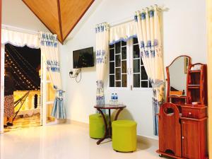 a living room with a window and a table at Pensee Guesthouse in Da Lat