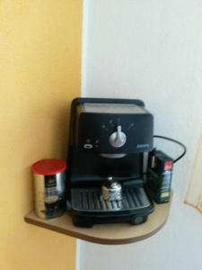 a coffee maker on a shelf on a wall at Rogoznica Apartment in Rogoznica