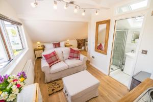 a living room with a bed and a couch at Sea View Holiday Flat - Covehurst Bay in Hastings +21 photos