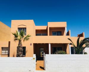 a house with a palm tree in front of it at Smart Villa Cabo de Palos in Cabo de Palos