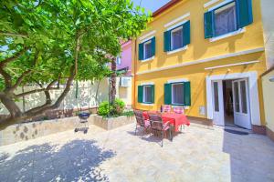 a patio with a table and chairs in front of a building at Little villa Tony- Center 40m beach Crikvenica in Crikvenica
