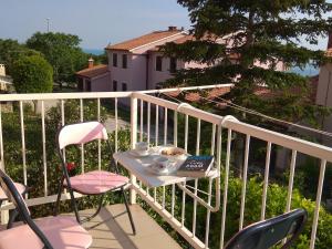 a table and two chairs on a balcony at Laura in Koromačno