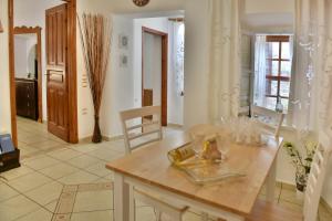 a kitchen with a table and a dining room at Kassandra House in Hydra