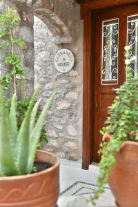 a entrance to a house with potted plants in front of a door at Kassandra House in Hydra