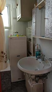 a bathroom with a white sink and a window at Country house Speri in Samos